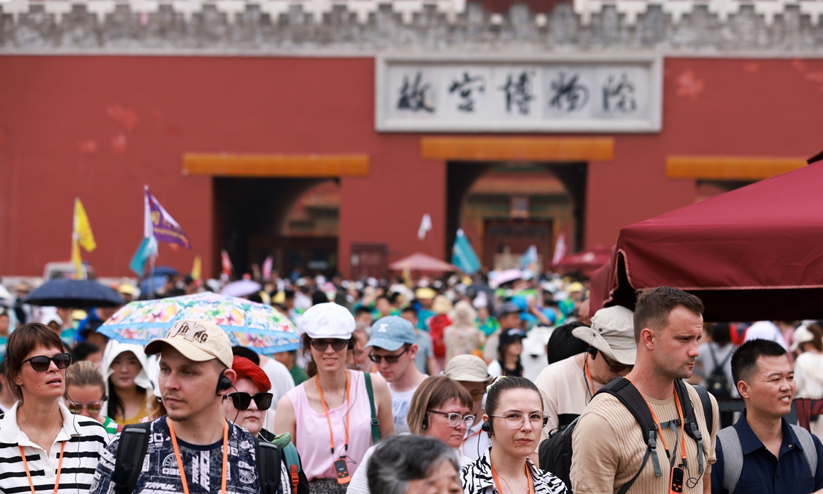 Groups of foreign tourists walk outside Beijing's Palace Museum on July 9, 2024. In the first half of the year, 14.635 million foreigners entered the country through various ports, an increase of 152.7 percent year-on-year, data from the National Immigration Administration showed. Among them, 8.542 million entered the country under visa-free policies. Photo: cnsphoto