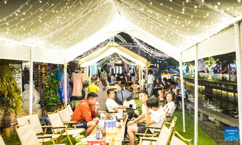 Tourists enjoy their leisure time at an ancient town in Zhongshan District of Liupanshui, southwest China's Guizhou Province, Aug. 8, 2024. Guizhou Province, with its cool climate and rich tourism resources, attracts tourists from all over the country during the peak summer travel season. (Photo: Xinhua)