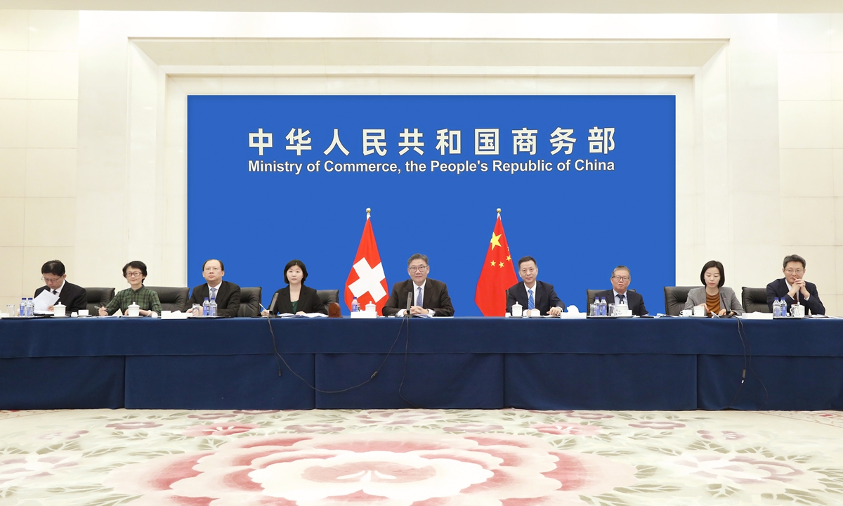 China's Minister of Commerce Wang Wentao talks with Swiss Federal Councilor Guy Parmelin, also head of the Federal Department of Economic Affairs, Education and Research via videoconference on Monday. Photo: China's Ministry of Commerce