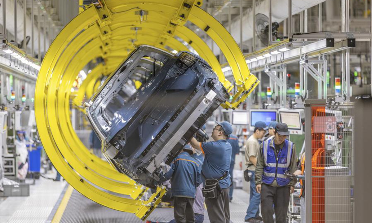 Employees work at an assembly line of Chinese vehicle manufacturer Seres Group in Liangjiang New Area, southwest China's Chongqing Municipality, April 25, 2024. (Xinhua/Huang Wei)