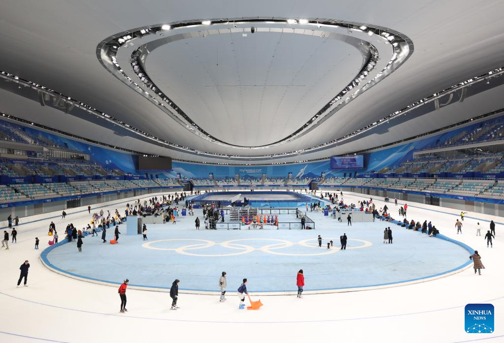 People have fun with ice and snow at National Speed Skating Oval in Beijing