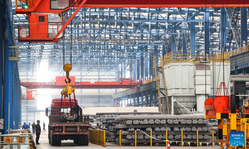 Workers of HBIS Group Shijiazhuang Iron and Steel Co., Ltd. hoist steel for transport in Shijiazhuang, north China's Hebei Province, Jan. 2, 2025. Enterprises across China are operating at full capacity to meet production demands at the start of the new year. (Photo by Liang Zidong/Xinhua)