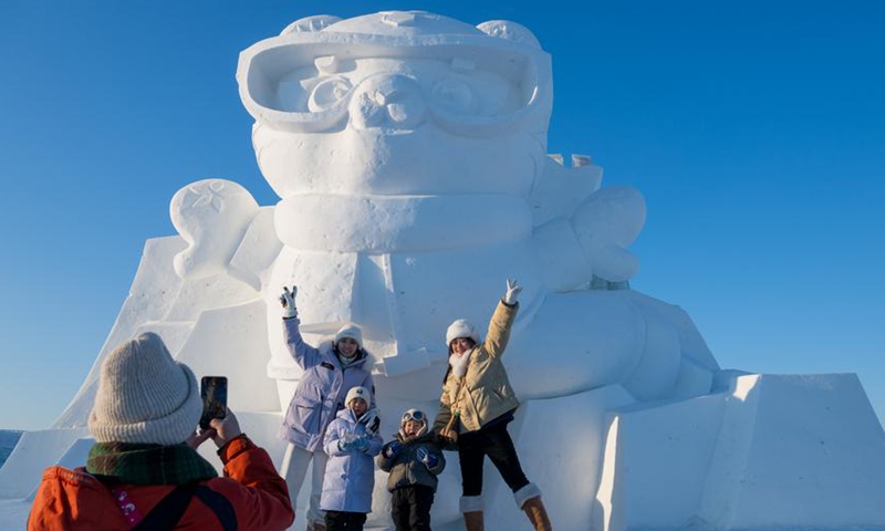 People pose for photos with a snow sculpture of Binbin, mascot of the 2025 Asian Winter Games, at the Harbin Ice-Snow World in Harbin, capital of northeast China's Heilongjiang Province, Jan. 3, 2025. Photo: Xinhua