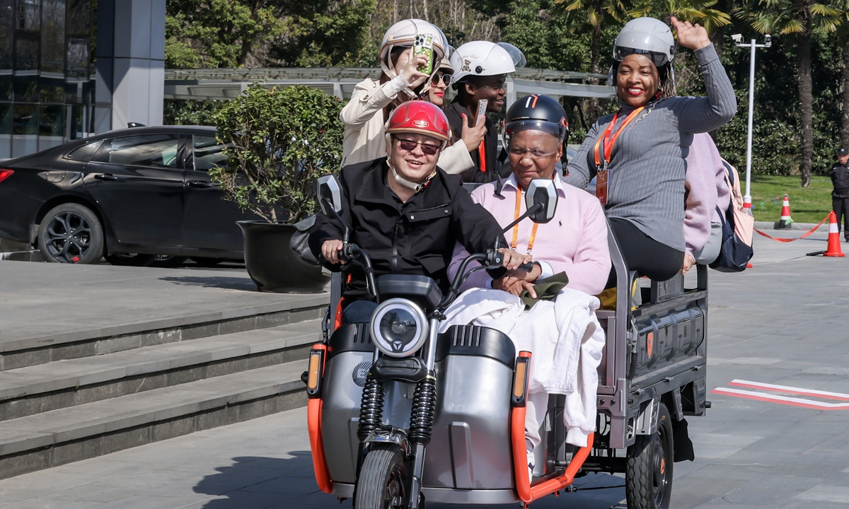 International visitors ride an electric tricycle made in Wuxi, East China's Jiangsu Province, on March 19, 2024. Photo: Courtesy of Ren Zhijun