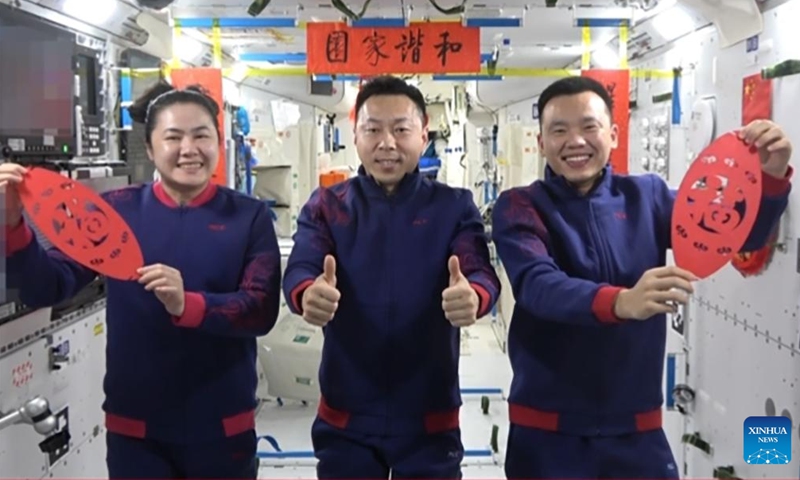 This undated video grab shows Shenzhou-19 astronauts sending their Spring Festival greetings from China's Tiangong space station. Shenzhou-19 astronauts Cai Xuzhe, Song Lingdong and Wang Haoze sent their Spring Festival greetings from China's Tiangong space station in a video released by the China Manned Space Agency (CMSA) on New Year's Eve. The trio, dressed in blue jumpsuits adorned with red traditional auspicious cloud patterns, held two pieces of Chinese paper-cutting featuring the character fu, symbolizing good luck. (Xinhua)